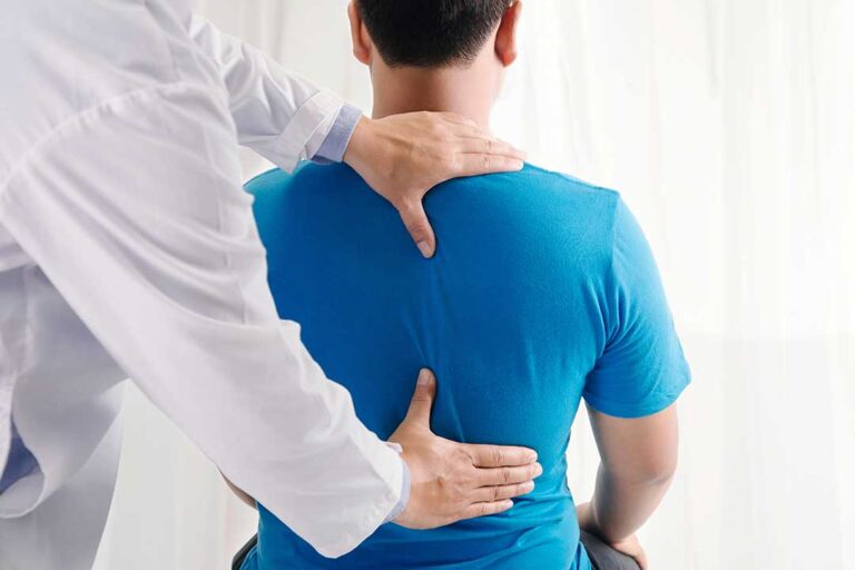 A chiropractor performing a gentle spinal adjustment on an adult patient in a clean, bright clinic setting.