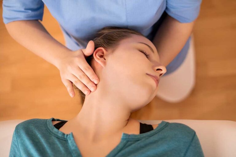 Person rolling to their side and pushing up from bed while managing lower back pain.
